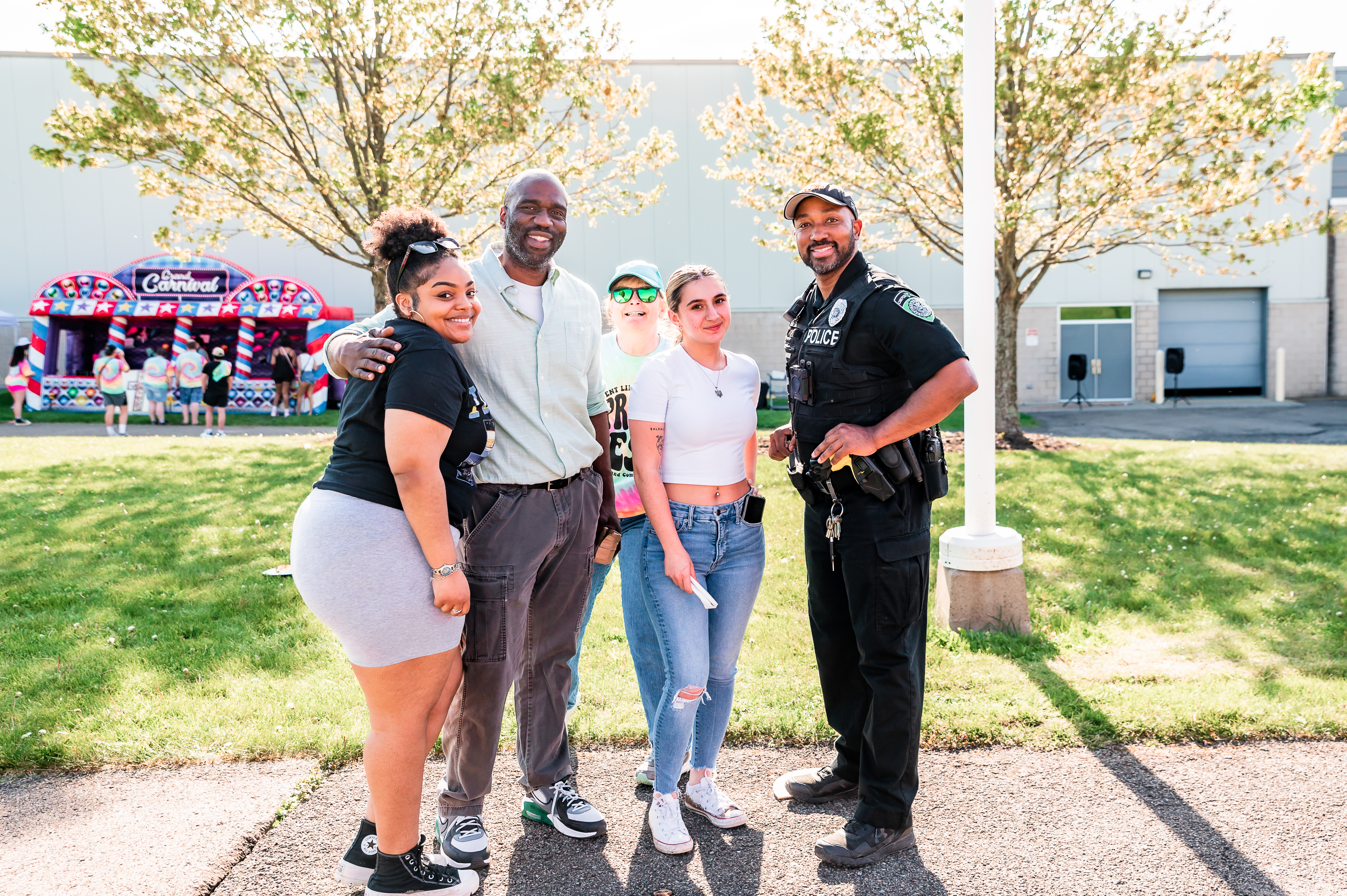 Campus police officer with students at Spring Fest