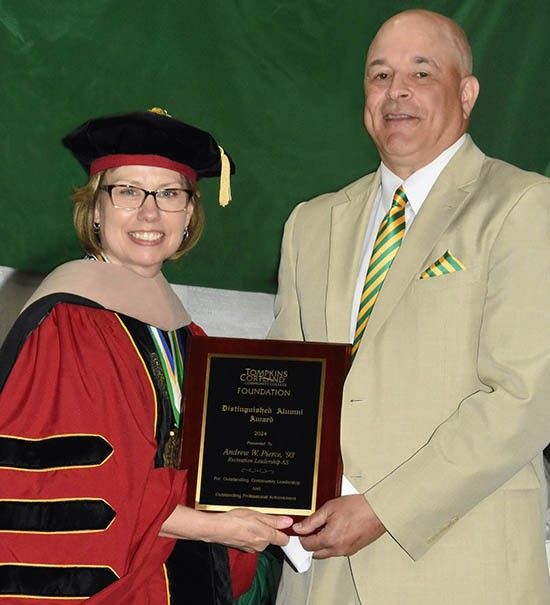 TC3 President Kremenek presenting plaque to 2024 Distinguished Alumni Winner Andrew Pierce