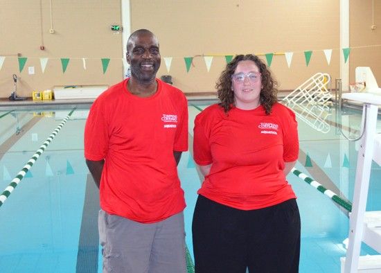 Alfred Okaru and Madisyn Zimmer in front of pool