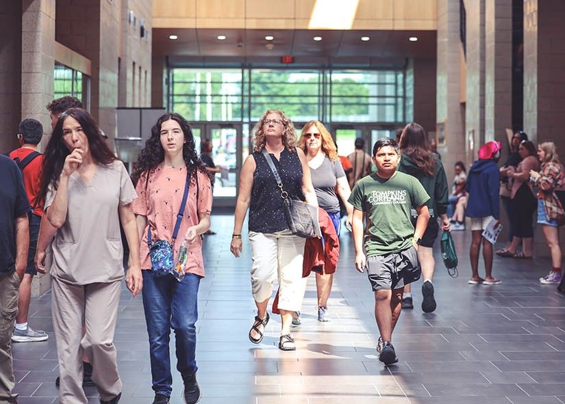 Students walking in the athletics facility atrium