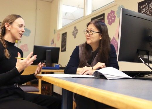 Tutor explaining material to attentive student